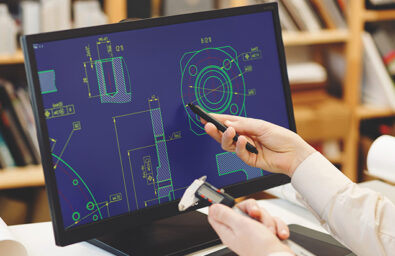 Engineer working on cad scheme using computer tools.