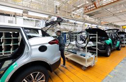 Minsk, Belarus - Dec 15, 2021: Car bodies are on assembly line. Factory for production of cars. Modern automotive industry. Electric car factory, conveyor.